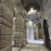 a stone building with an archway and a door