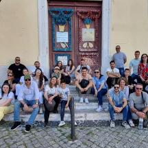 a group of people posing for a picture in front of a building