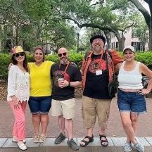 a group of people posing for a picture in a park