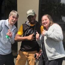 two men and a woman giving the thumbs up