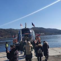 a group of people boarding a bus on a river