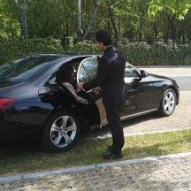 a man standing next to a black car
