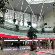an airport with a large building with people in it