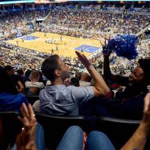a group of people sitting in the audience at a basketball game
