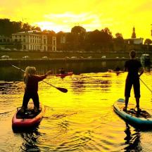 two people are on paddle boards in the water