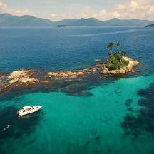 an island with a boat in the middle of the water