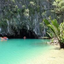 a group of people in a boat in a cave