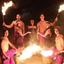 a group of people standing in front of fire