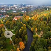 an aerial view of a park with a pond and trees