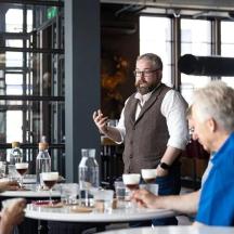 a man standing at a table in a restaurant