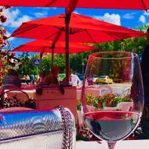 a glass of wine sitting on top of a table