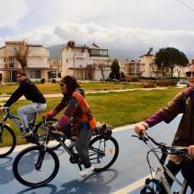 a group of people riding bikes down a street