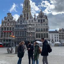 a group of people standing in front of a large building