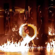 a person is dancing with fire on a stage