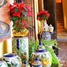 a group of vases sitting on the side of a building