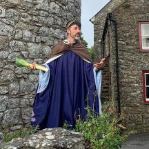 ein Mann in einer Robe steht vor einem Gebäude