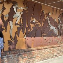 a woman standing in front of a mural on a wall