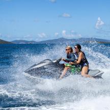 two people riding on a jet ski in the water