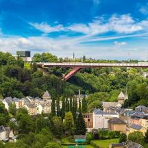 a train is crossing a bridge over a city