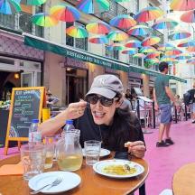 a woman sitting at a table with a plate of food