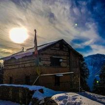 a building with a flag in the snow