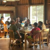 a group of people sitting at a table in a restaurant