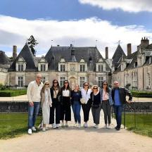 a group of people standing in front of a castle