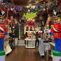 a store filled with christmas decorations and christmas trees