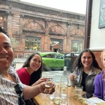 a group of people sitting at a table with wine glasses