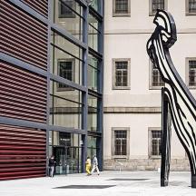 a sculpture of a woman in front of a building
