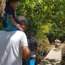 a man carrying a young child on his shoulders