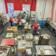 a group of people in a kitchen preparing food
