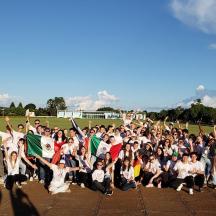 a large group of people with their hands in the air