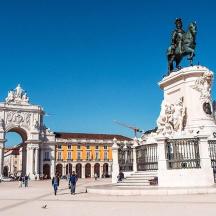 a statue of a man on a horse in front of a building