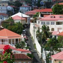 arial view of a city with houses with red roofs