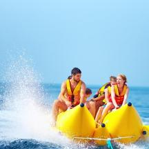 a group of people sitting on a yellow raft in the water