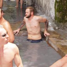 a group of men standing in the water