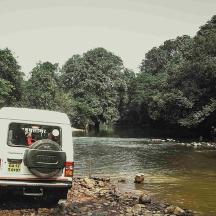 a white van parked in front of a river