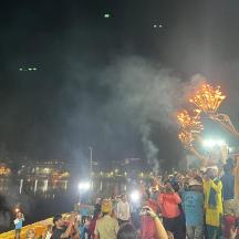 eine Menschenmenge, die in der Nähe eines Flusses mit Feuerwerk steht