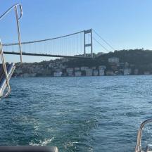 a boat in the water with a bridge in the background