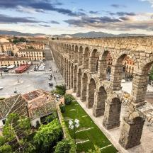 a view of a city with an aqueduct
