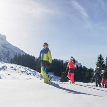 a group of people standing on a snow covered mountain