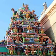 a colorful tower with figurines on the side of a building