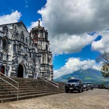 an old building with cars parked in front of it