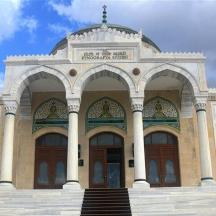 a large building with two doors and stairs in front