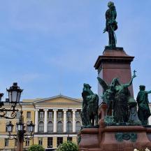 a statue in front of a large building