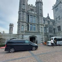 a van parked in front of a large building