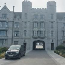 a car parked in front of a large building