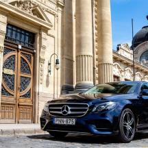a blue car parked in front of a building