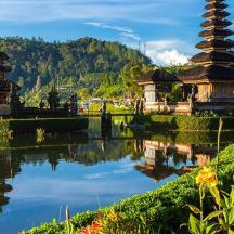 a reflection of two pagodas in a body of water